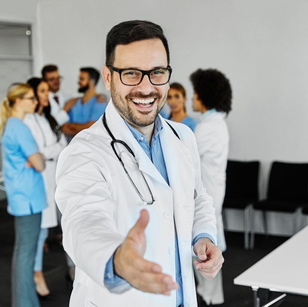 doctor portrait man hospital medical handshake hand agreement deal greeting partnership offer